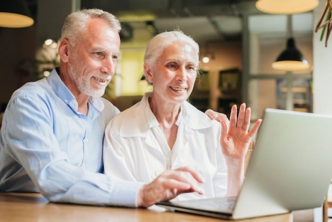 Old couple looking at a laptop